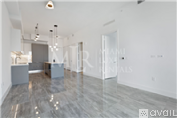 A spacious room with marble flooring and a white ceiling.