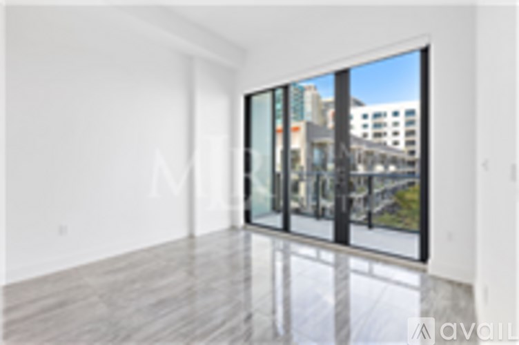 A large empty room with a view of the city outside.