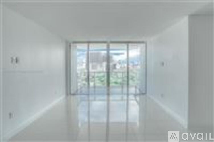 A long hallway with a glass door at the end.