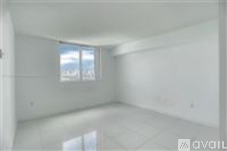 A white room with a window and a door.