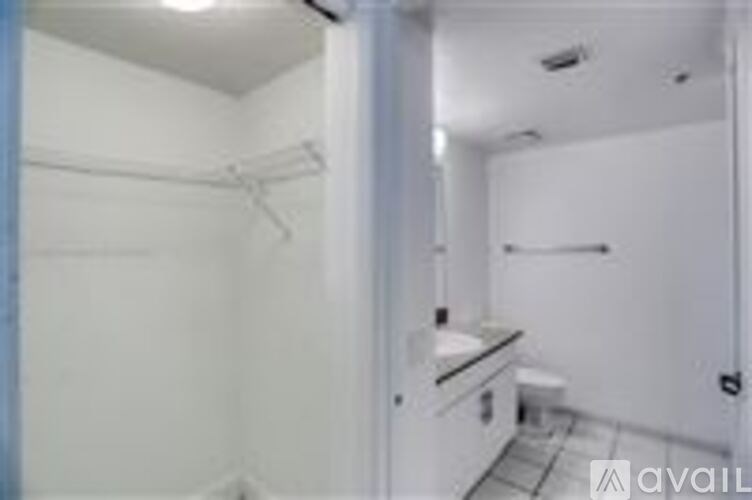 A bathroom with a toilet, sink, and a towel rack.