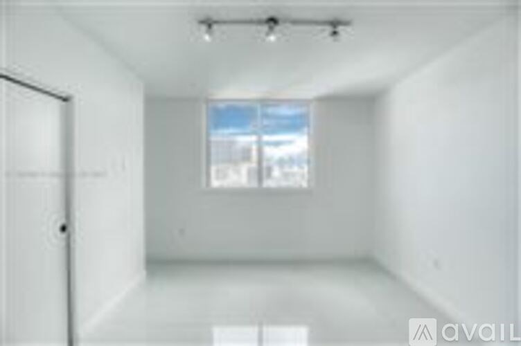 A white room with a window and a door.