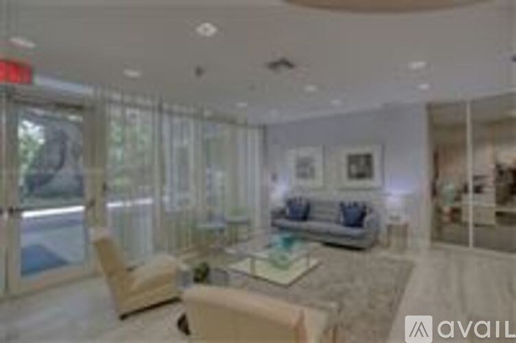 A living room with a couch, chair, and glass doors.