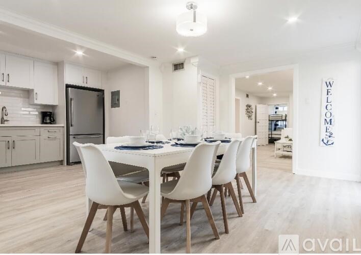 A modern dining room with a large table and chairs.