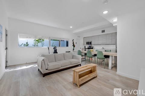 A living room with a grey sofa and a wooden coffee table.