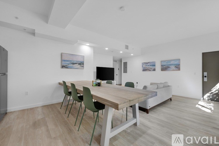 A modern dining room with a wooden table and chairs.