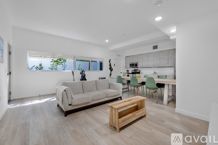 A living room with a grey sofa and a wooden coffee table.