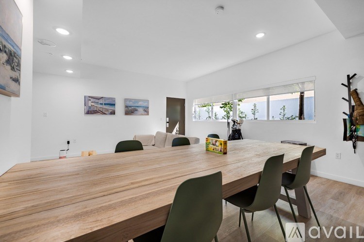 A wooden table with chairs and a box on it in a room.