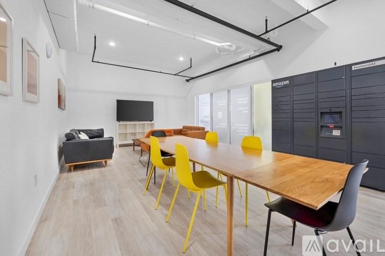 A conference room with a long table and yellow chairs.