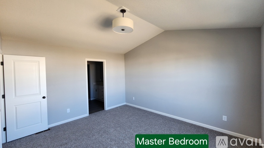 A room with a door and a carpeted floor is labeled as the master bedroom.