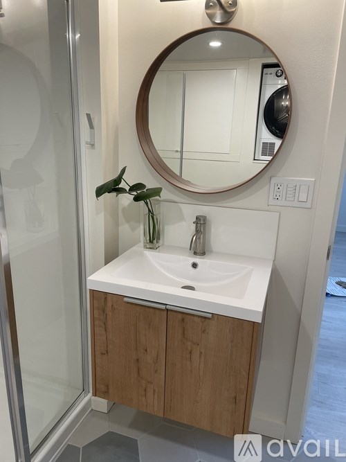 A bathroom with a sink and mirror.