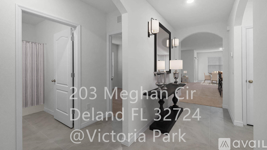 A hallway with a mirror and a door leading to a bedroom.