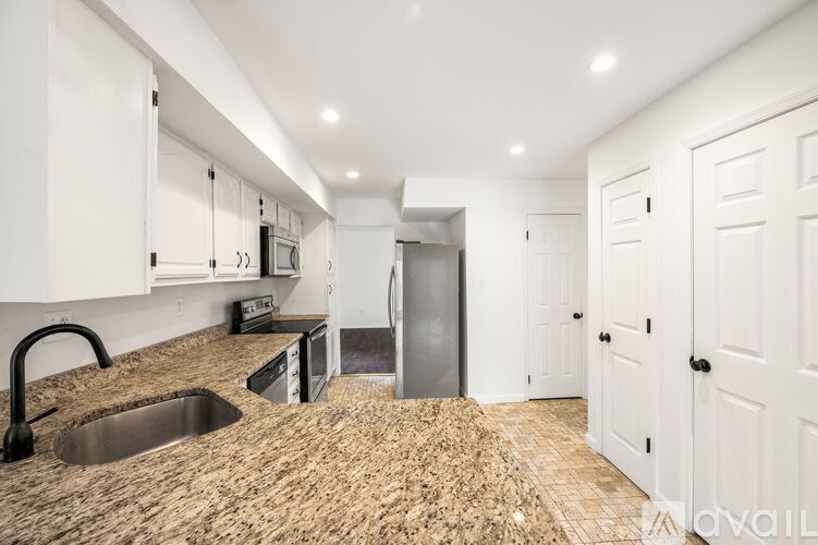 A kitchen with a sink and cabinets.