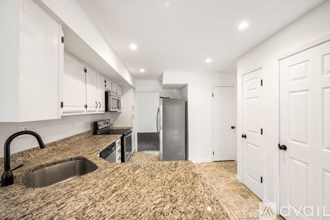 A kitchen with a sink and cabinets.