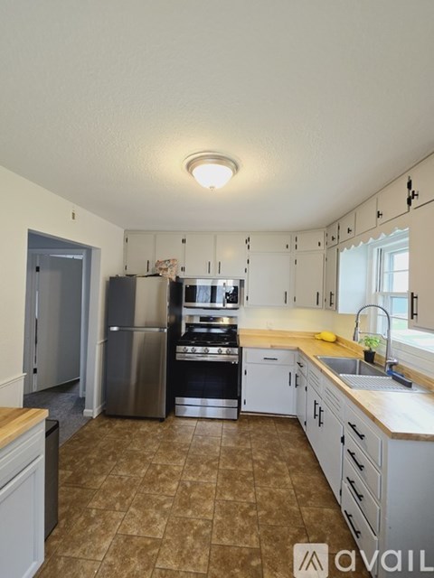 A kitchen with a refrigerator, stove, and oven.