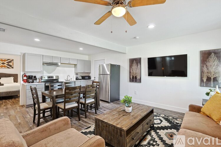 A living room with a dining table and chairs.