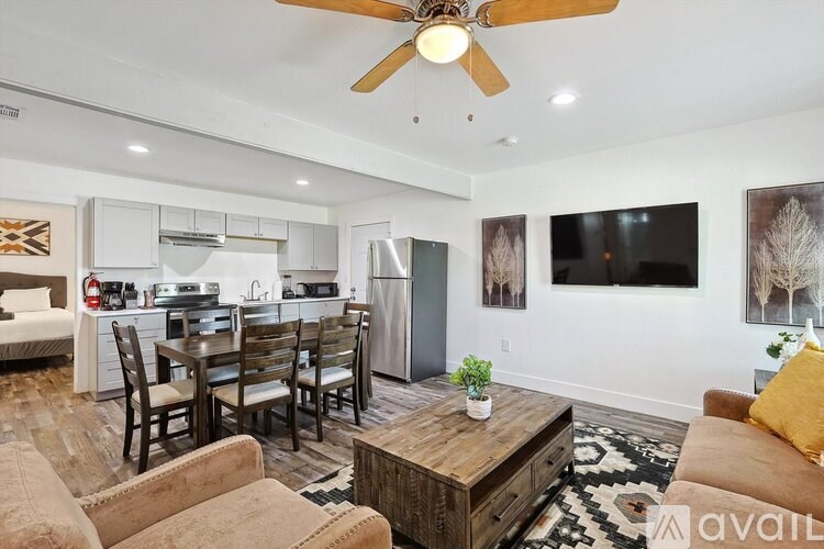 A living room with a dining table and chairs.