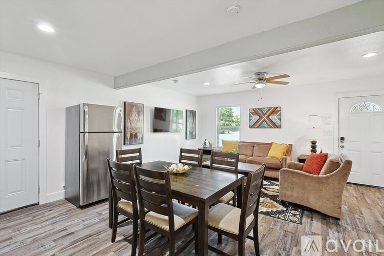 A kitchen with a table and chairs in the middle of the room.