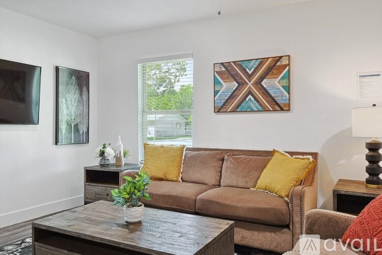 A living room with a brown couch and a wooden coffee table.