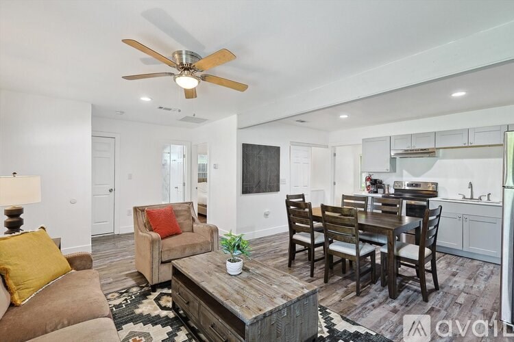 A living room with a brown couch and a wooden coffee table.
