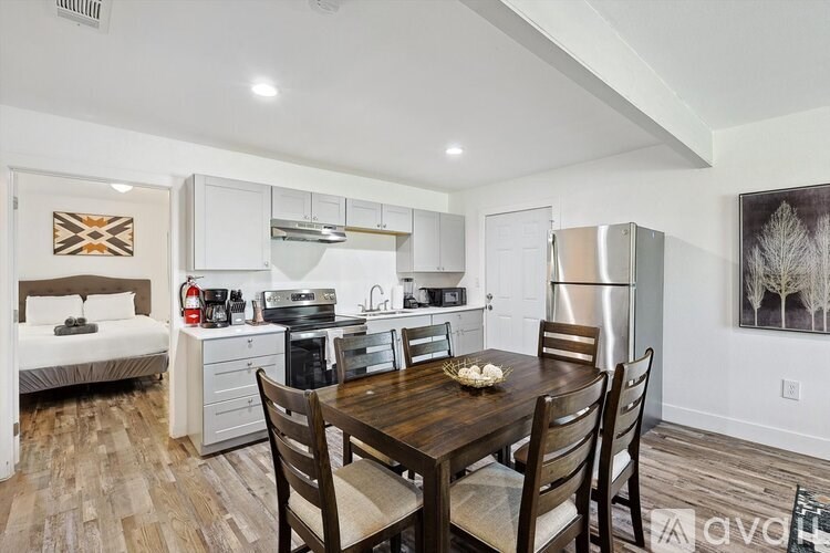 A kitchen with a table and chairs in the middle of the room.