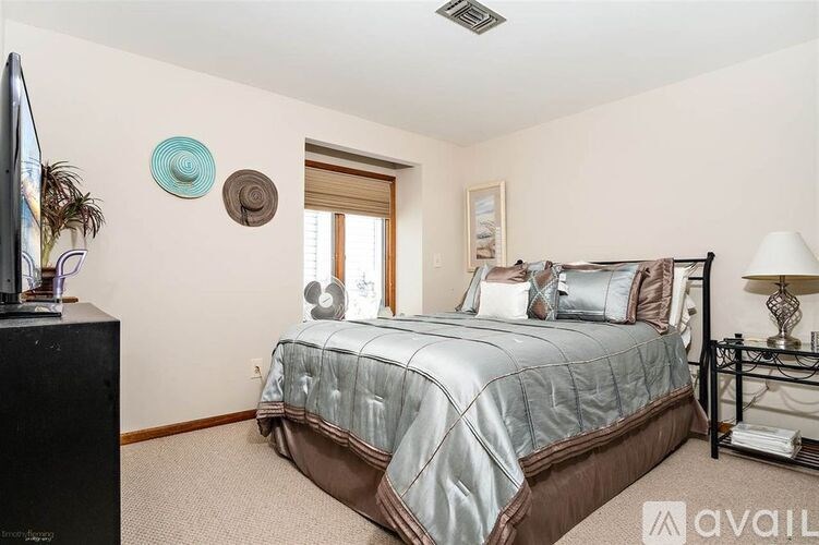 A bedroom with a large bed and a television.