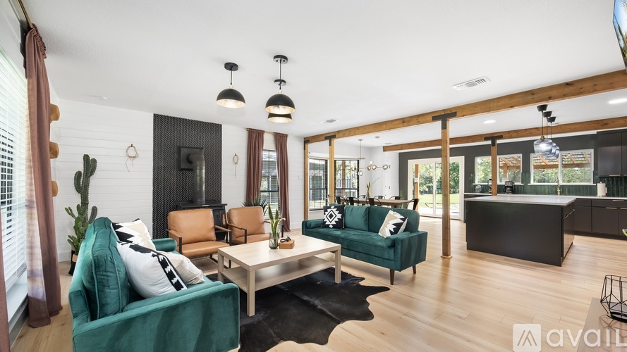 A living room with a green couch and a wooden floor.