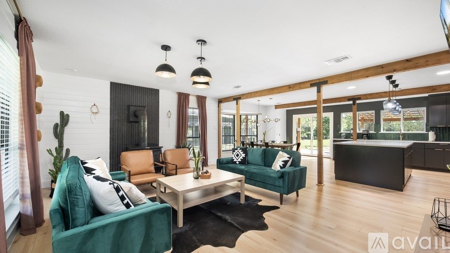A living room with a green couch and a wooden floor.
