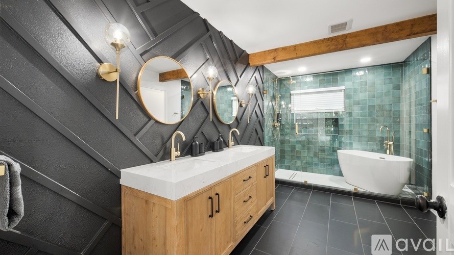 A modern bathroom with a wooden vanity and a white sink.
