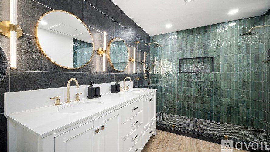 A bathroom with a white countertop and gold fixtures.