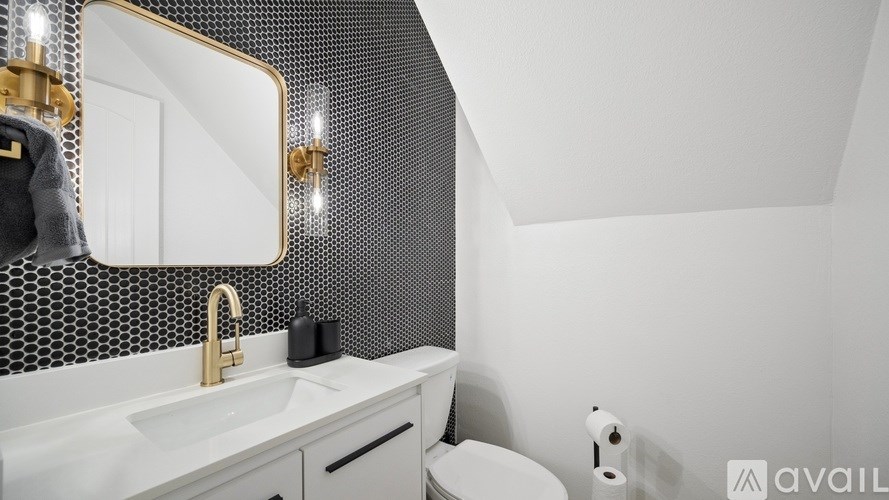 A bathroom with a white sink and a mirror above it.