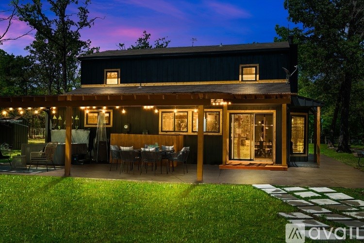 A house with a patio and lights on it.