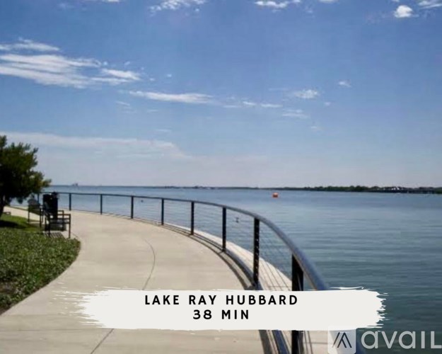 A walkway with a railing and a sign that says Lake Ray Hubbard 38 min.