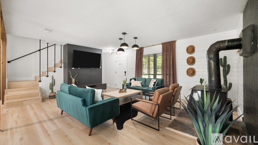 A living room with a green couch and a television.