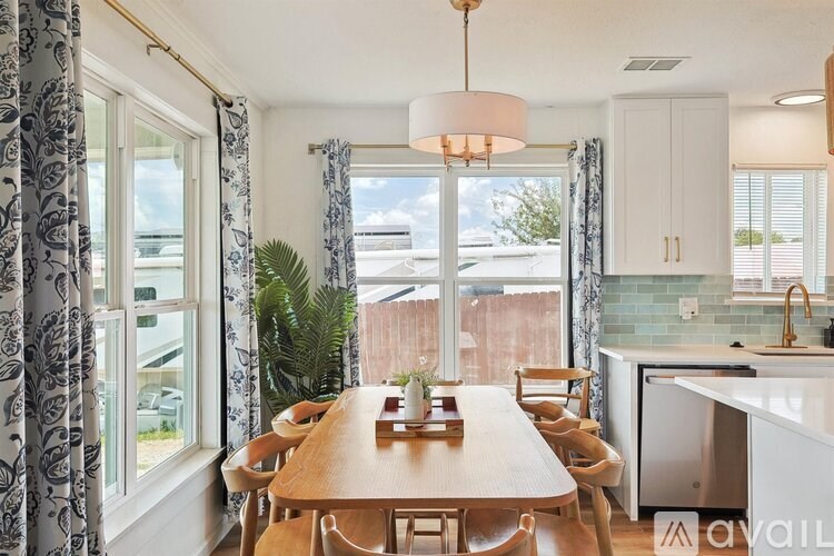 A dining room with a wooden table and chairs.