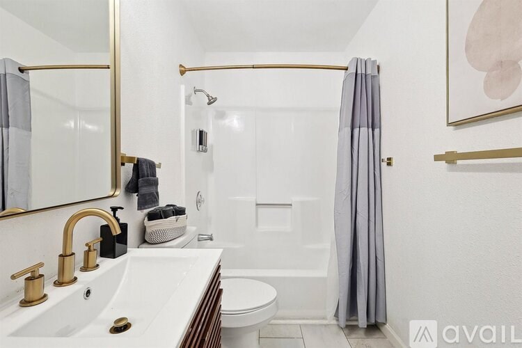 A bathroom with a white sink and a white toilet.