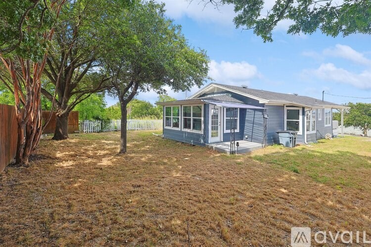 A blue house with a tree in front of it.