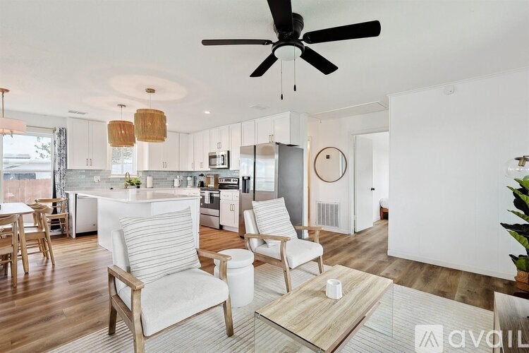 A modern kitchen with a dining table and chairs.