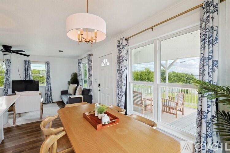 A dining room with a wooden table and chairs.