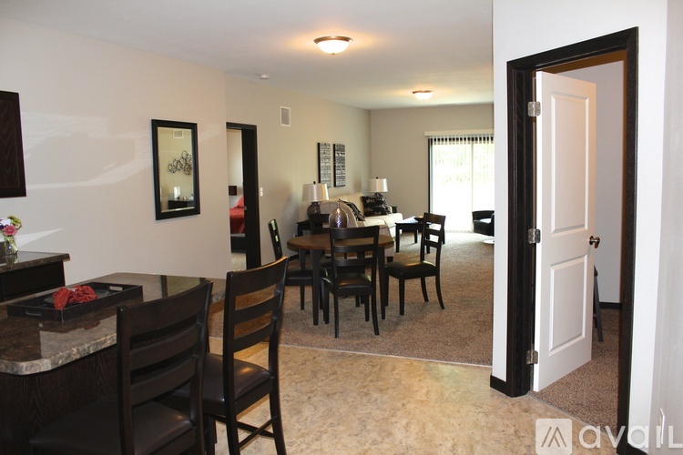 A dining room with a table set for six.
