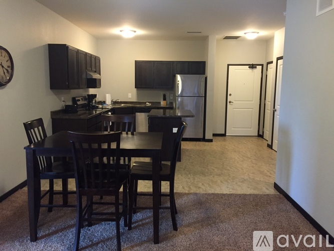 A kitchen with a dining table and chairs.