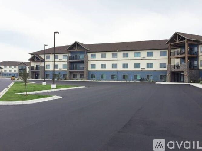 A large building with a parking lot in front of it.