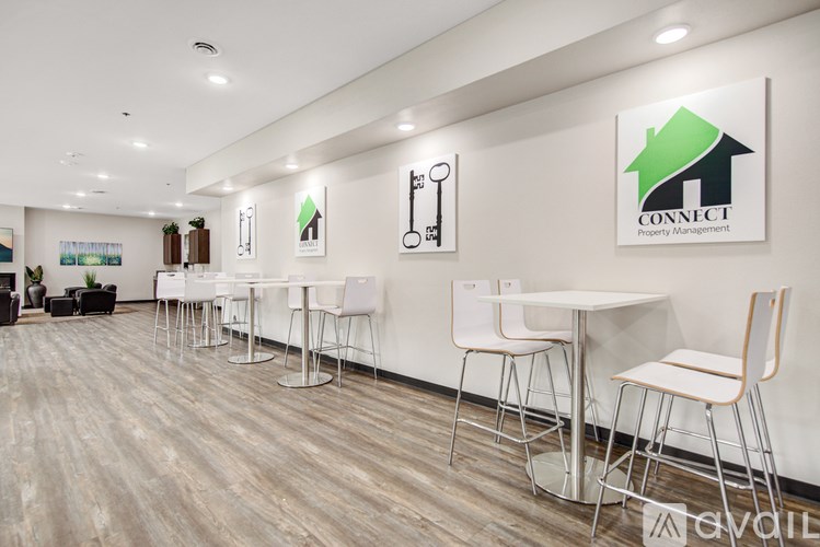 A white table with chairs is in front of a wall with a Connect Property Management logo.