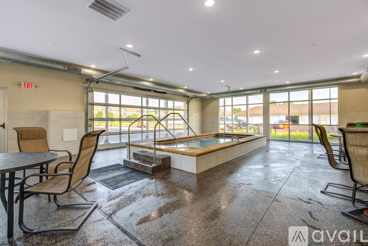 A room with a table, chairs and a pool table.