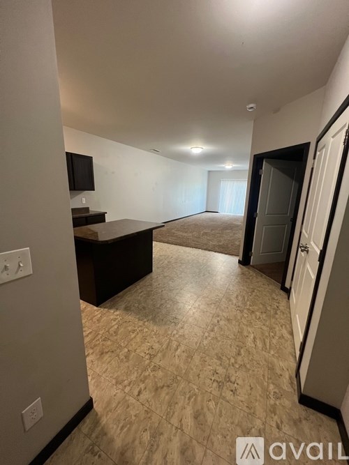 A living room with a television and a door leading to another room.