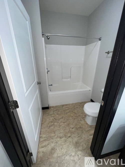 A bathroom with a toilet, tub, and shower.