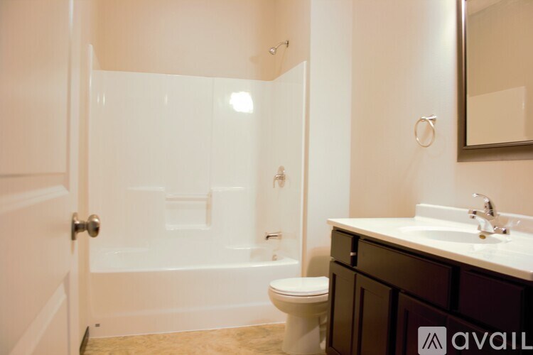 A bathroom with a toilet, sink, and shower.