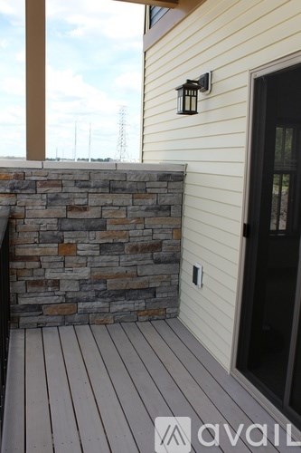 A house with a black door and a stone wall.