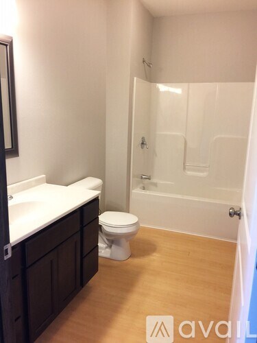 A bathroom with a toilet, sink, and shower.