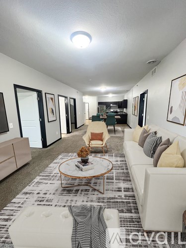 A living room with a white couch and a coffee table.